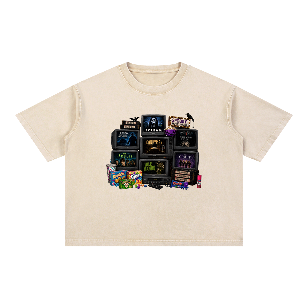 A cream-colored short-sleeve t-shirt with a graphic print of vintage horror movie VHS tapes and candy, displayed flat against a solid white background.