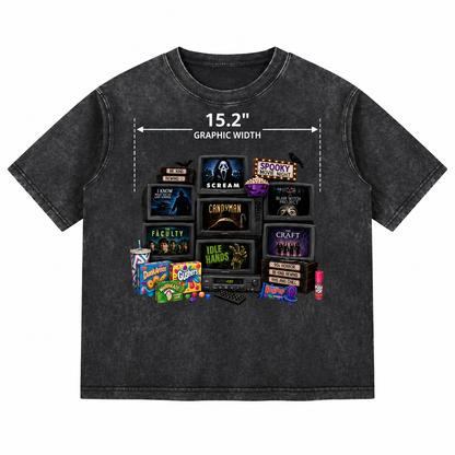 A dark gray acid-wash graphic t-shirt featuring a collage of TV screens and candy brands from Scream, with a white graphic width measurement overlay.